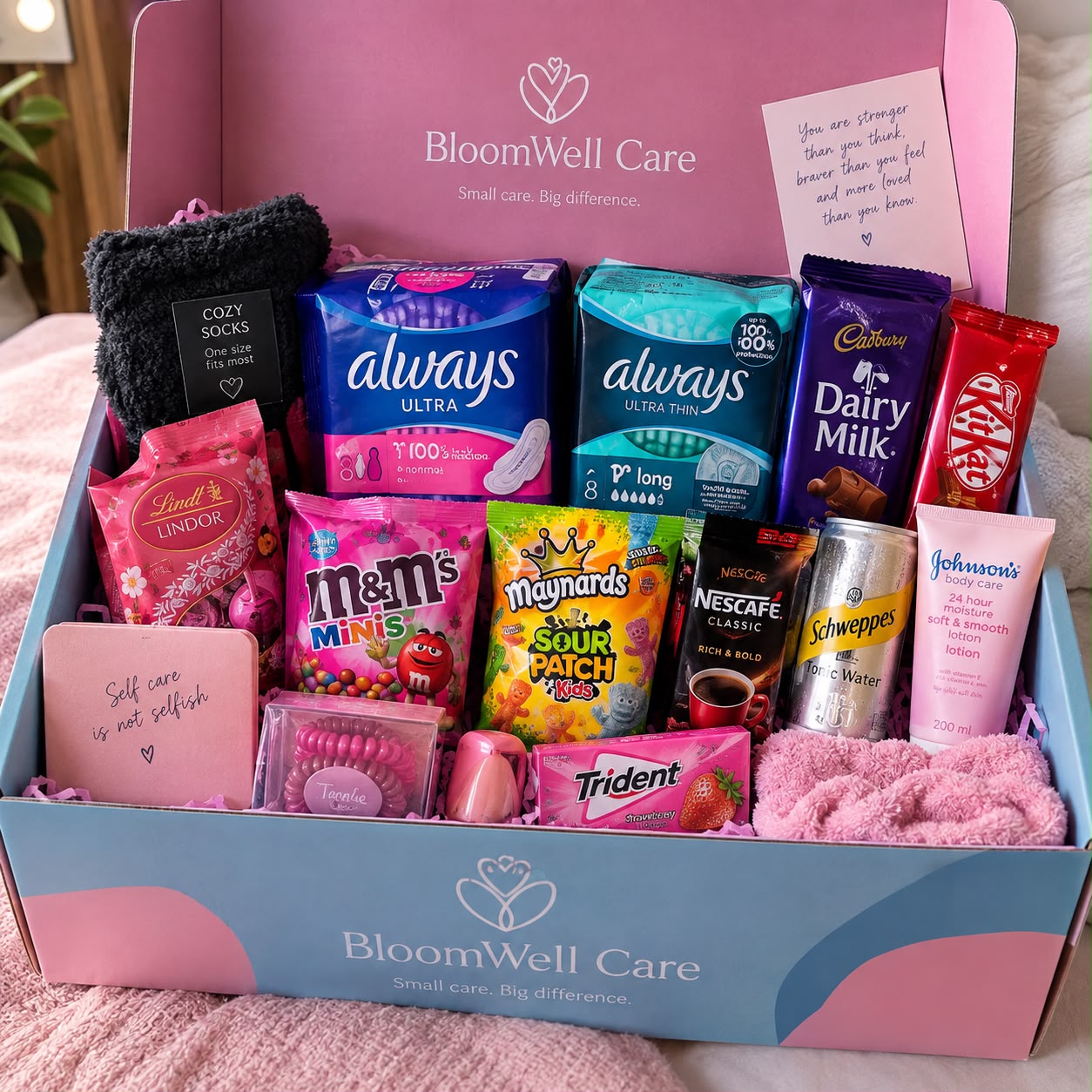 An open Bloomwell box filled with pads, chocolates, socks and a handwritten note